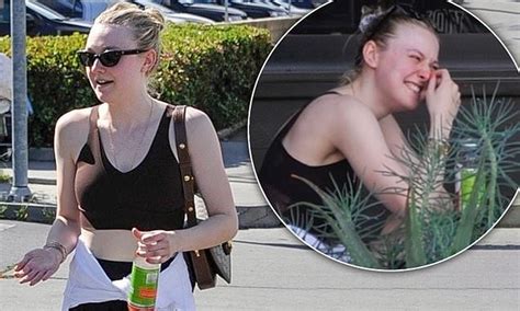Dakota Fanning Flaunts Her Toned Abs In A Crop Top As She Grabs A Juice