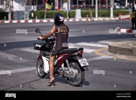 female riding motorcycle and watching policeman thailand southeast