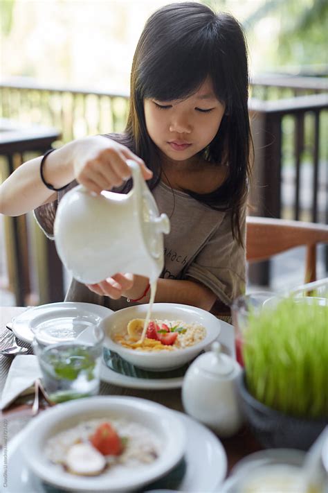 Cute Asian Girl Is Eating Rich Healthy Breakfast In By Stocksy
