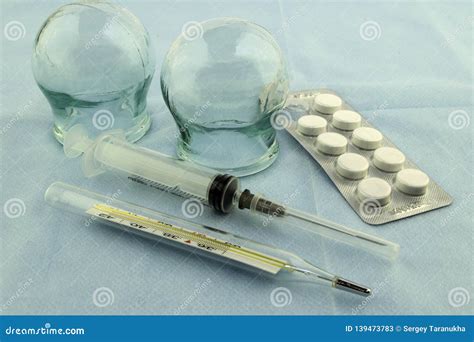 glass massage medical banks  thermometer  syringe  pills stock