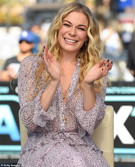 leann rimes offers up an eyeful of cleavage in frilly purple dress