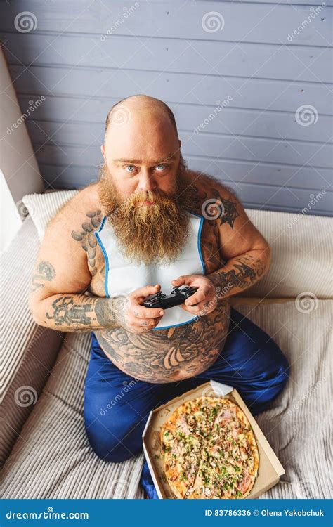 hungry fat man holding joystick stock photo image  adult enjoyment