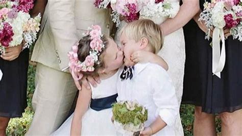 adorable flower girl steals kiss  ring bearer