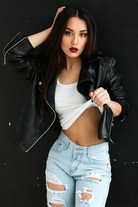 Sexy Female Model In Black Leather Jacket And Ripped Jeans
