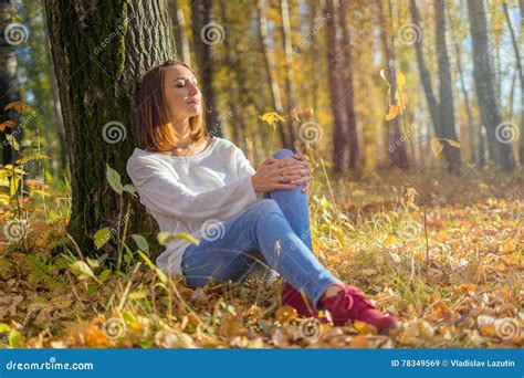 girl sitting   tree   forest stock image image  shoes