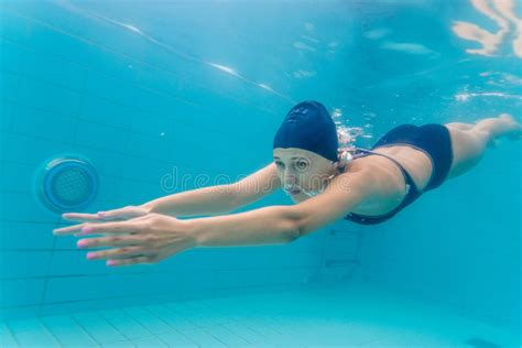 woman swimming underwater in pool stock image image of