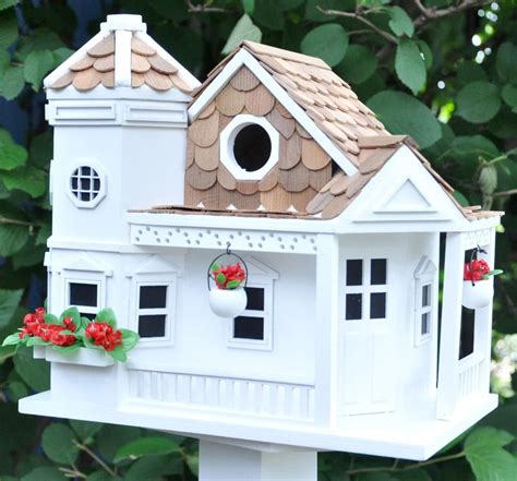 large white bird houses white cottage cottage style  standing bird feeders attract wild