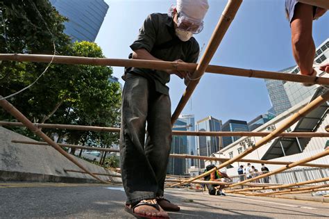 hong kong protesters rebuild barricades after scuffles police warn of