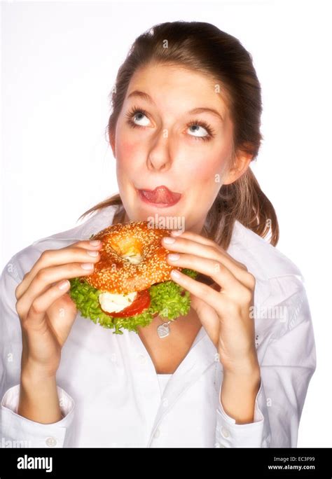 woman eating bagel stock photo  alamy