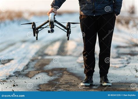 man walking  preparing white drone  digital camera  flying stock image image