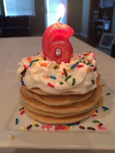 funfetti mini pancakes lotsa whipped cream sprinkles and pretty candle for birthday morning