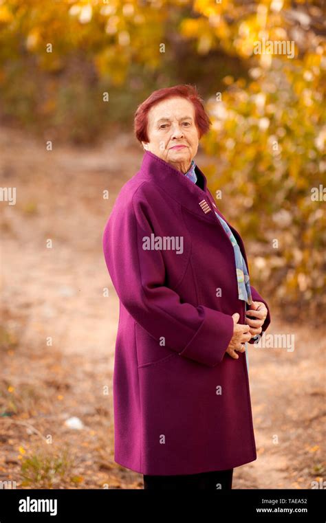 smiling senior woman 70 80 year old wearing stylish winter coat posing