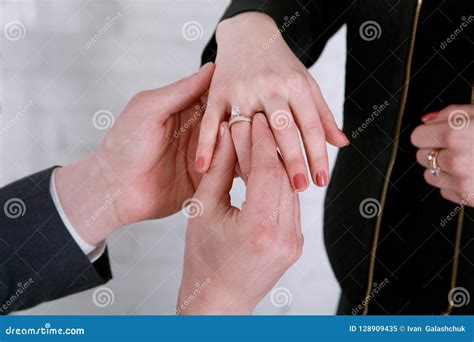Groom`s Hand Putting A Wedding Ring On The Bride`s Finger Wedding Stock