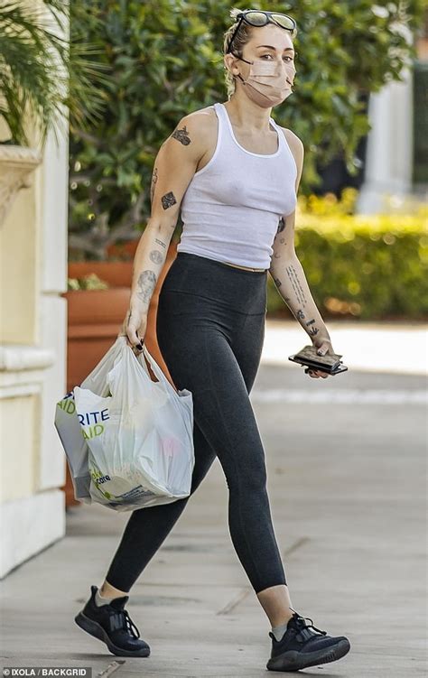 braless and bold miley cyrus makes a statement in a white tank top
