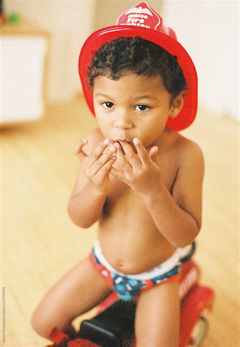 mixed race little fire fighter by stocksy contributor marlon