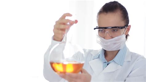 female scientist mixing chemicals  volumetric flask stock footage video  shutterstock