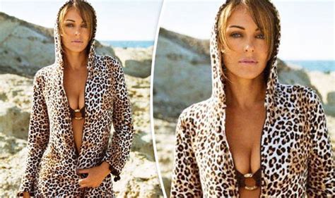 elizabeth hurley highlights ample bust as she squeezes