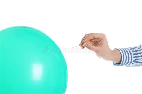 woman piercing inflated condom with pin on background