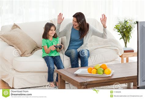 mom looking at her daughter playing video games royalty free stock image image 17469206