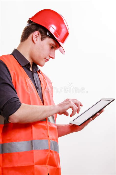 Man Worker In Safety Vest Hard Hat Using Tablet Stock