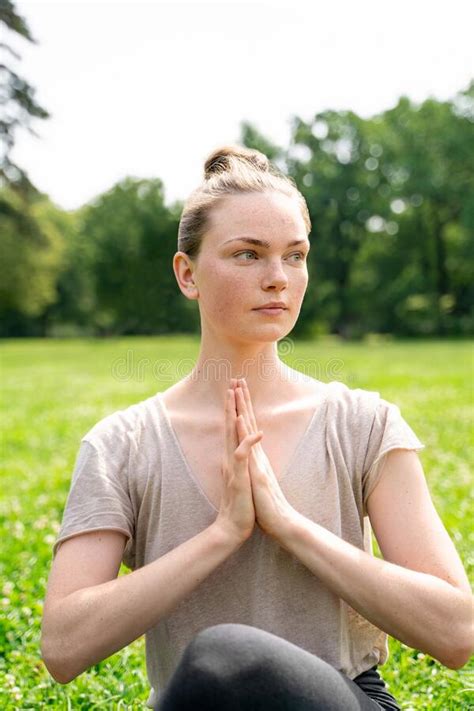 young fit blond woman sitting  lotus yoga pose  hands