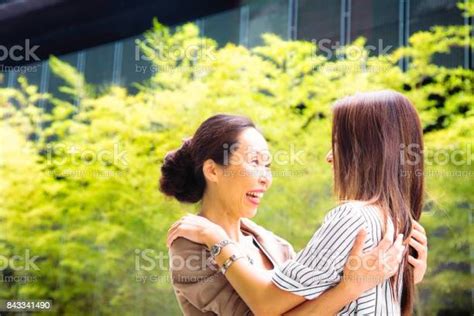 japanese mature mother welcomes her daughter and smiles at her