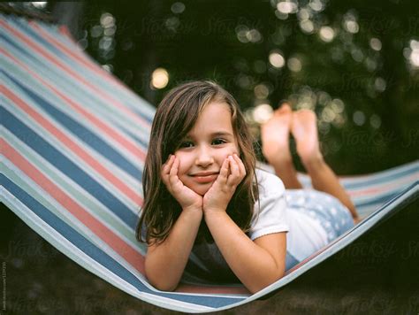 Beautiful Young Girl Relaxing In A Hammock By Stocksy Contributor