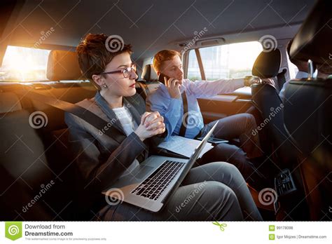 Successful Business People Working Together In Back Seat