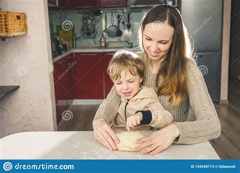 mother and son in kitchen making dough stock image image of bake