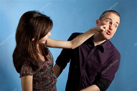 Man Punching Woman In Face