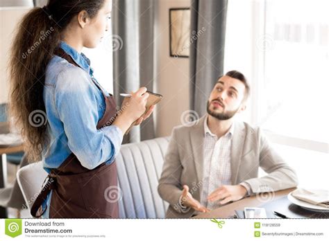 man sharing his taste preference with waitress stock image image of