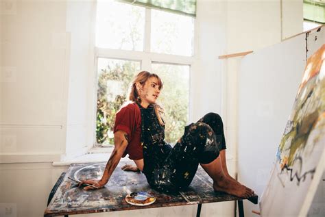 pensive female painter working  studio stock photo