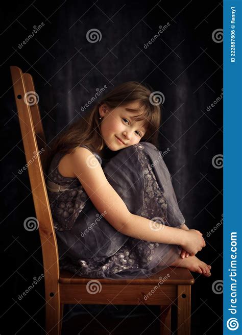 Full Length Portrait Of A Cute Fair Haired Caucasian Girl In A Dress