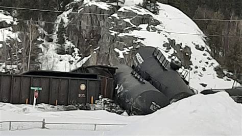 train cars derailed petroleum coke spilled  creek east  prince