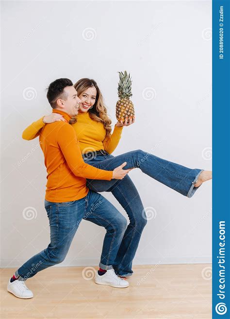 Funny Couple Fool Around And Dance Holding A Pineapple In Her Hand