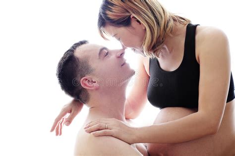 husband listening the belly of his pregnant asian wife isolated on white background stock image
