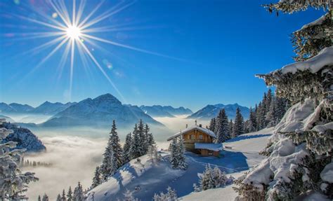 winter sun rays cottage snow mountain forest snowy peak blue landscape nature