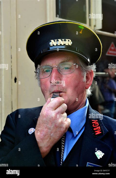 train guard  north norfolk railway blowing departure whistle