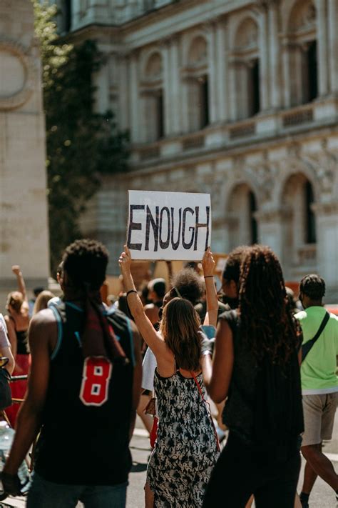 people holding  signage  daytime photo  current