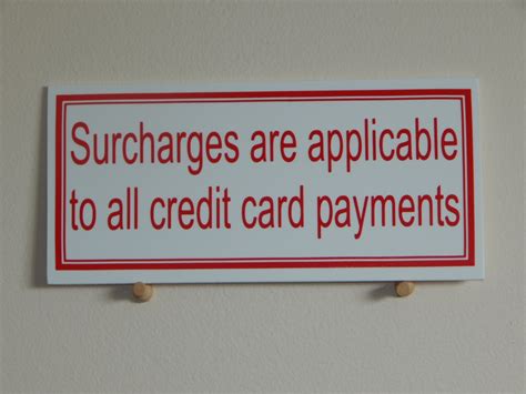 merchants charge  extra  swiping  card   paying
