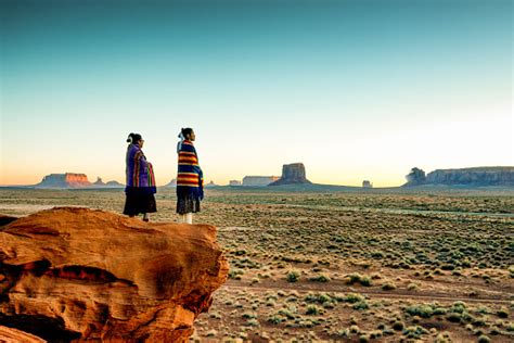two traditional navajo native american sisters in monument valley