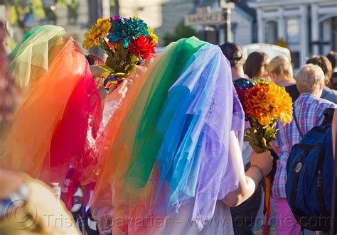 lesbian couple in rainbow color wedding dresses