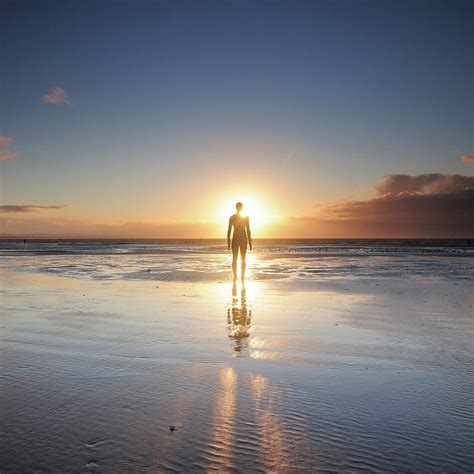 man walking  beach  sunset photograph  stu meech