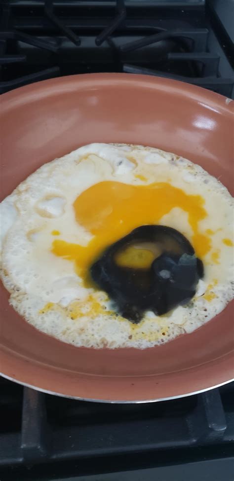 cracked open  egg    black yolk
