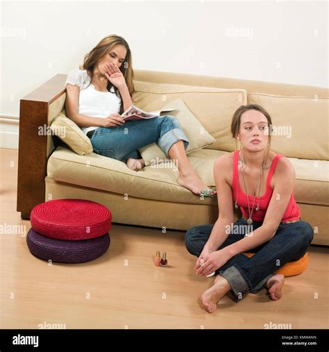 Pictures In A Living Room Of Two Young Girls Sitting On A Couch Getting