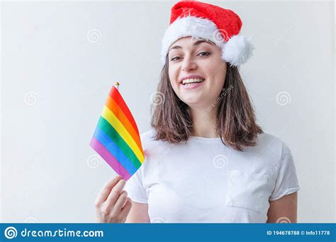 Beautiful Lesbian Girl In Red Santa Claus Hat With Lgbt Rainbow Flag