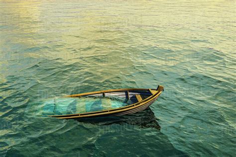 abandoned sinking rowboat  ocean stock photo dissolve