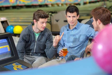 Three Friends In Bowling Alley Chatting Stock Image Colourbox