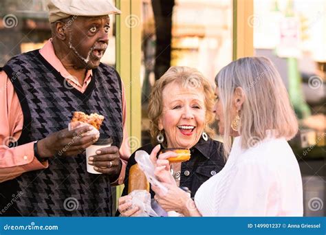 seniors eating donuts outdoors stock image image  gray
