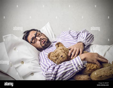 Man Sleeping In Bed With Teddy Bear